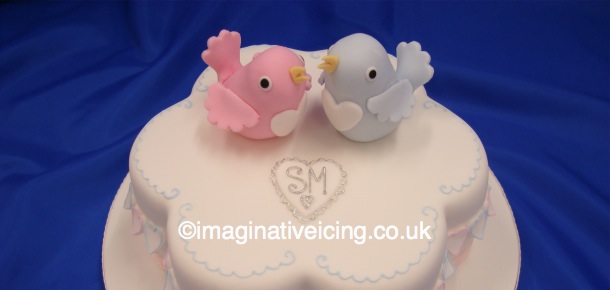 Love Birds A petal shaped cake with icing Hearts round the sides 