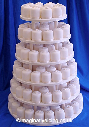 Ivory Mini Cakes Wedding Cake Tiered on Pillars